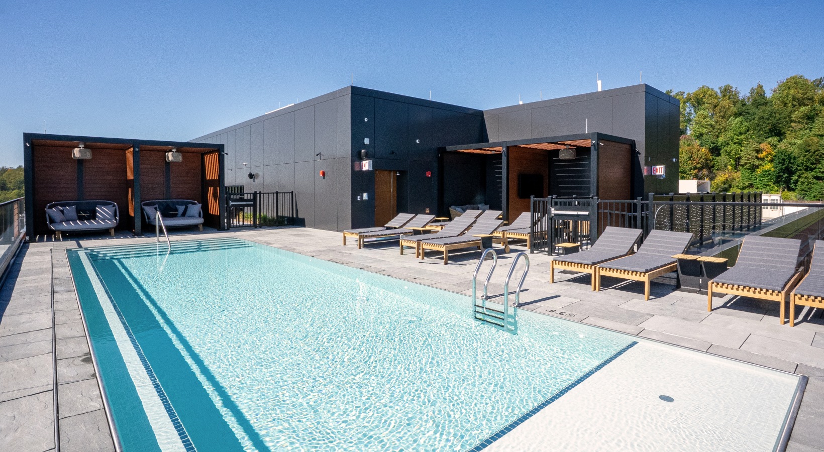 Rooftop pool with lounge and cabana seating 