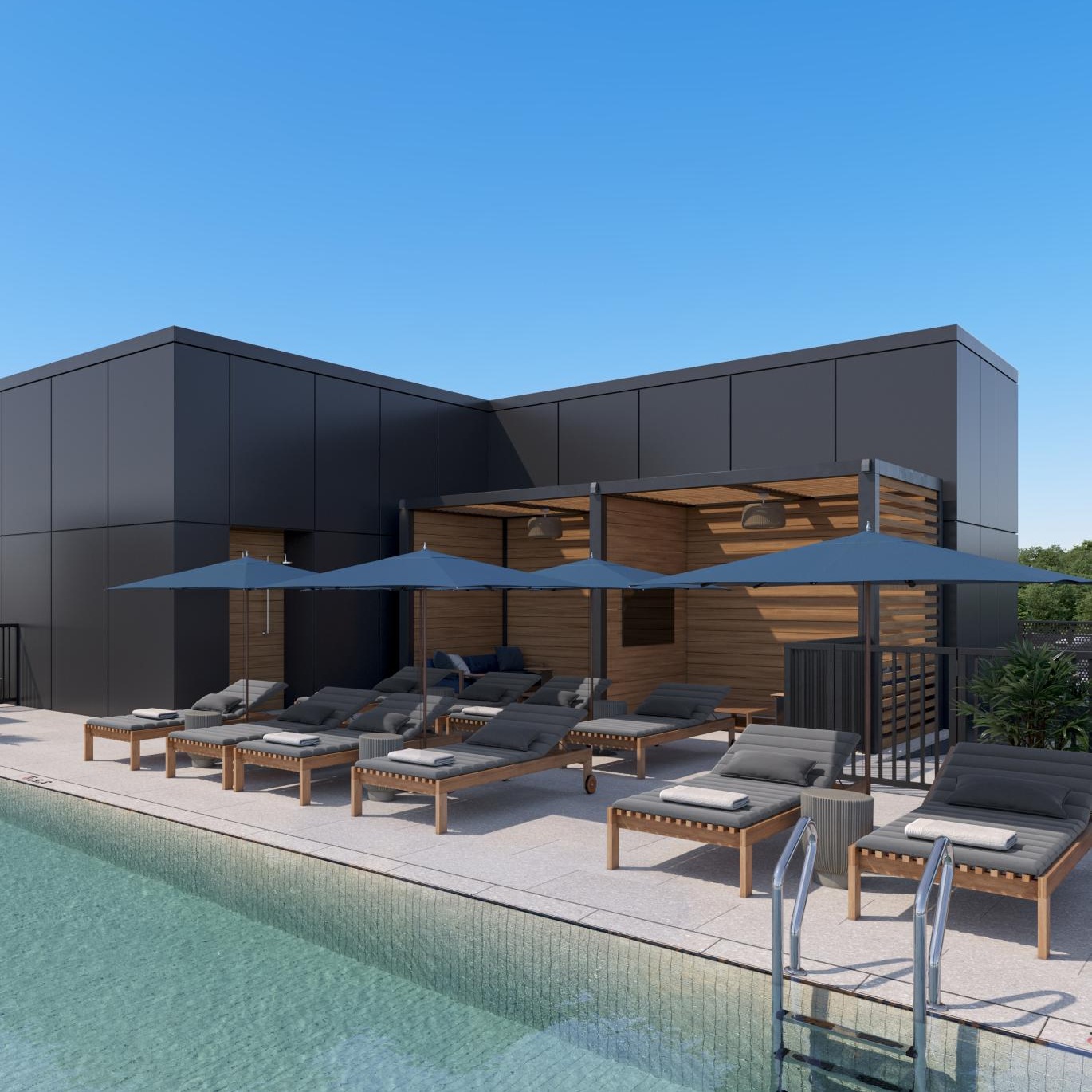 a swimming pool with chairs and umbrellas next to a building